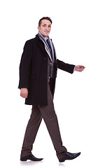 Image showing side view of a walking business man