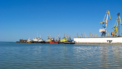 Image showing morning sea with hoisting crane in the seaport