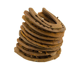 Image showing stack of old retro horse shoes isolated on white 