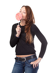 Image showing Attractive smiling female holding a lollipop