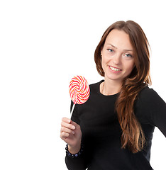 Image showing Attractive smiling female holding a lollipop