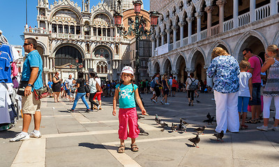 Image showing 16. Jul 2012 - Small girl with pigeons in St Marco Square, in front of Doge's Palace in Venice, Italy