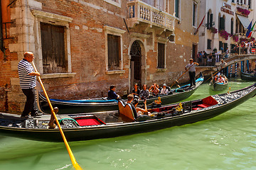 Image showing 16. Jul 2012 - Gondolier with tourists at canal in Venice, Italy