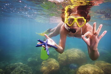 Image showing girl in scuba mask holding starfish