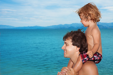 Image showing Dad carry kid on shoulders