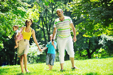 Image showing happy young couple with their children have fun at park