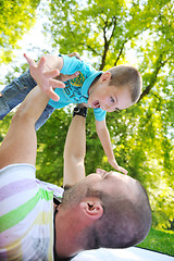 Image showing happy father and son have fun at park