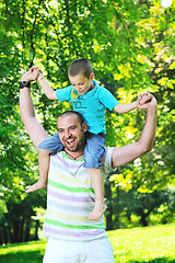 Image showing happy father and son have fun at park