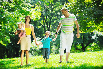 Image showing happy young couple with their children have fun at park