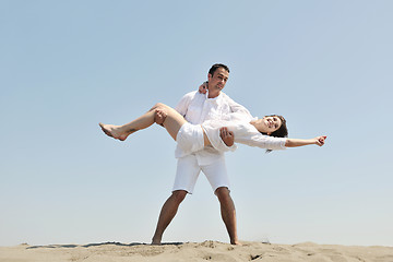 Image showing happy young couple have fun on beach