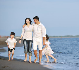 Image showing happy young family have fun on beach at sunset