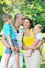 Image showing happy young couple with their children have fun at park