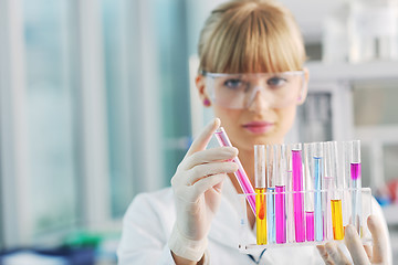 Image showing female researcher holding up a test tube in lab