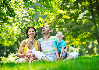 Image showing happy young couple with their children have fun at park