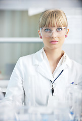 Image showing female researcher holding up a test tube in lab