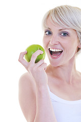 Image showing happy  young  woman eat green apple isolated  on white