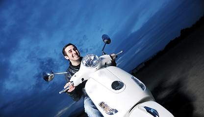 Image showing young man ride retro scooter