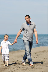 Image showing happy father and son have fun and enjoy time on beach