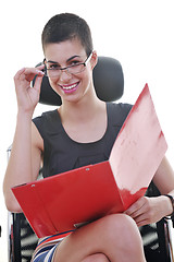 Image showing brunette female  model posing on business chair