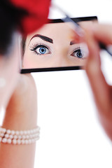 Image showing beautiful young woman applying makeup