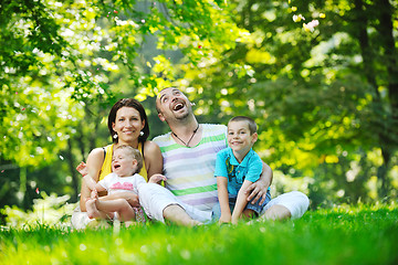 Image showing happy young couple with their children have fun at park