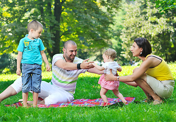 Image showing happy young couple with their children have fun at park