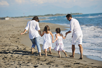 Image showing happy young  family have fun on beach