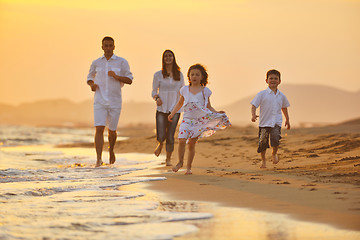 Image showing happy young family have fun on beach at sunset