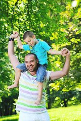 Image showing happy father and son have fun at park