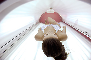 Image showing Beautiful young woman tanning in solarium