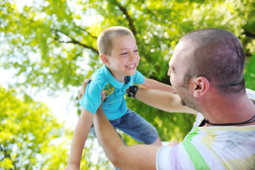 Image showing happy father and son have fun at park