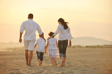 Image showing happy young family have fun on beach at sunset