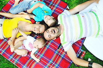 Image showing happy young couple with their children have fun at park