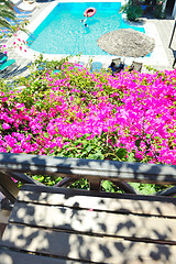 Image showing romantic balcony with flowers and pool view