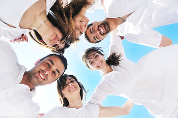 Image showing Group of happy young people in circle at beach