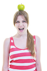 Image showing happy  young  woman eat apple isolated  on white