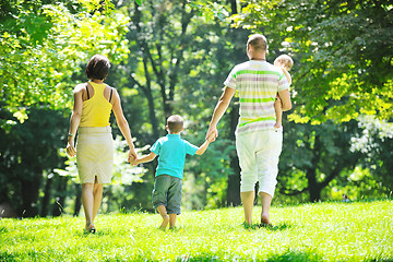 Image showing happy young couple with their children have fun at park