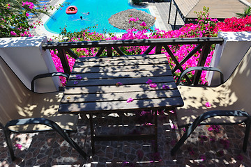 Image showing romantic balcony with flowers and pool view