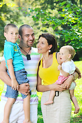 Image showing happy young couple with their children have fun at park