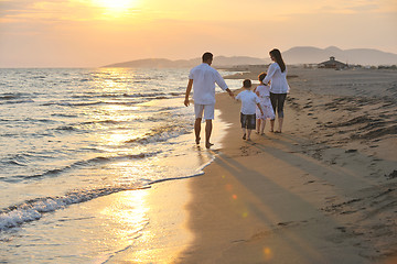 Image showing happy young family have fun on beach at sunset