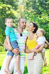 Image showing happy young couple with their children have fun at park