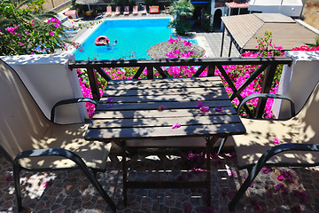 Image showing romantic balcony with flowers and pool view