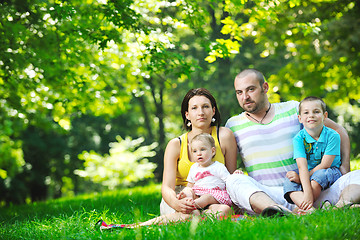 Image showing happy young couple with their children have fun at park