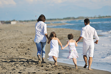 Image showing happy young  family have fun on beach