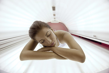 Image showing Beautiful young woman tanning in solarium