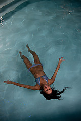 Image showing pretty young lady  relaxing in the swimming pool