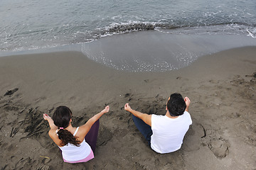 Image showing couple yoga beach