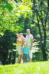Image showing happy young couple with their children have fun at park