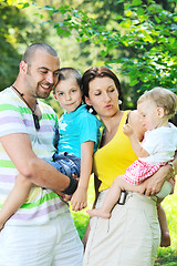 Image showing happy young couple with their children have fun at park