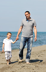 Image showing happy father and son have fun and enjoy time on beach